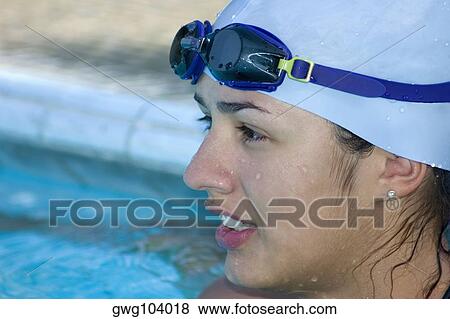 Close-up of a young woman in a swimming pool View Large Photo Image Stock Photo - Close-up of a young woman in a swimming pool. Fotosearch