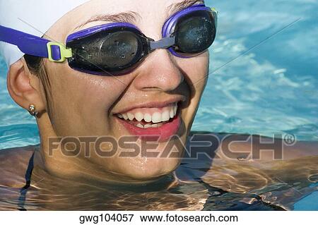 Close-up of a young woman in a swimming pool View Large Photo Image Stock Photo - Close-up of a young woman in a swimming pool. Fotosearch