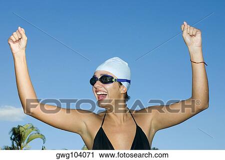 Close-up of a young woman laughing with her hand raised View Large Photo Image Stock Image - Close-up of a young woman laughing with her hand raised. Fotosearch