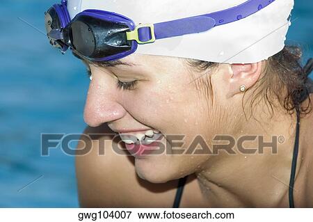 Close-up of a young woman smiling in swimwear View Large Photo Image Stock Photo - Close-up of a young woman smiling in swimwear. Fotosearch