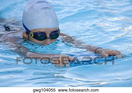 Close-up of a young woman swimming in a swimming pool View Large Photo Image Stock Photography - Close-up of a young woman swimming in a swimming pool. Fotosearch