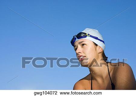 Low angle view of a young woman in swimwear View Large Photo Image Stock Image - Low angle view of a young woman in swimwear. Fotosearch
