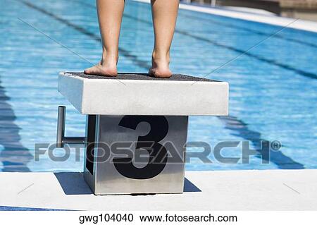 Low section view of a person standing on the diving platform View Large Photo Image Stock Image - Low section view of a person standing on the diving platform. Fotosearch