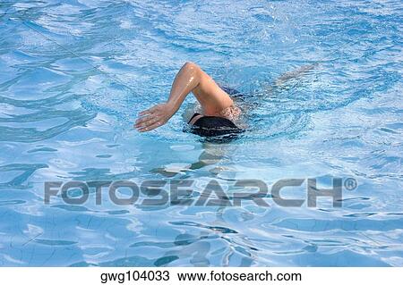 Man swimming in a swimming pool View Large Photo Image Stock Image - Man swimming in a swimming pool. Fotosearch