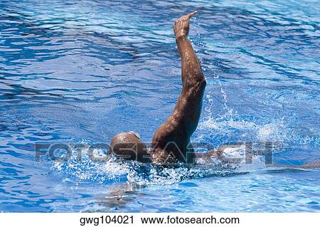 Mid adult man swimming in a swimming pool View Large Photo Image Stock Image - Mid adult man swimming in a swimming pool. Fotosearch