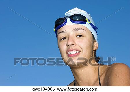 Portrait of a young woman smiling in swimwear View Large Photo Image Stock Photography - Portrait of a young woman smiling in swimwear. Fotosearch