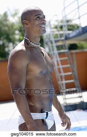 Side profile of a mid adult man standing at the poolside and smiling View Large Photo Image Stock Photography - Side profile of a mid adult man standing at the poolside and smiling. Fotosearch