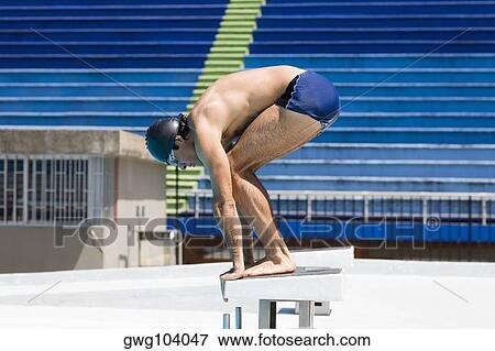 Stock Photo - Side profile of a young man in diving position. Fotosearch