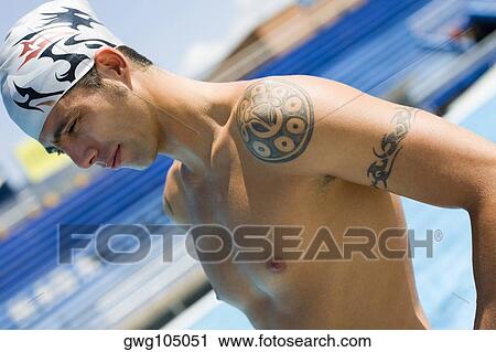 Close-up of a mid adult man standing at the poolside View Large Photo Image Stock Image - Close-up of a mid adult man standing at the poolside. Fotosearch