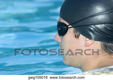 Close-up of a young man in a swimming pool View Large Photo Image Stock Photograph - Close-up of a young man in a swimming pool. Fotosearch