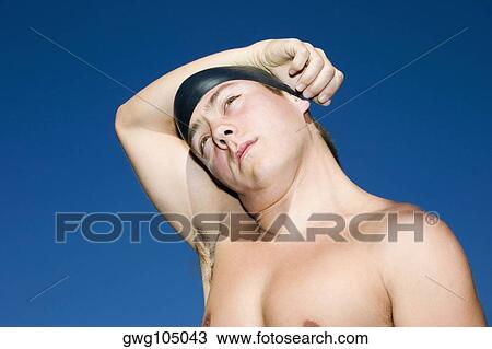 Close-up of a young man with his hand on his head View Large Photo Image Stock Image - Close-up of a young man with his hand on his head. Fotosearch