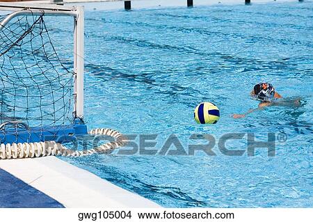 Man playing water polo in a swimming pool View Large Photo Image Picture - Man playing water polo in a swimming pool. Fotosearch