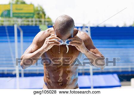 Mid adult man wearing swimming goggles View Large Photo Image Stock Photo - Mid adult man wearing swimming goggles. Fotosearch