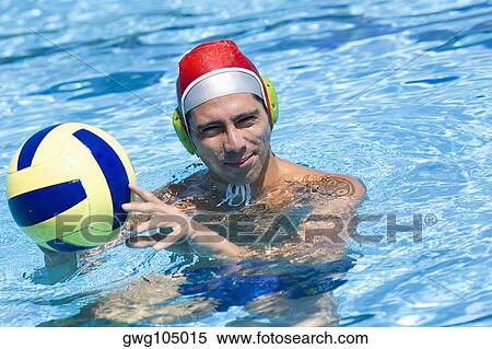 Portrait of a mid adult man holding a ball in a swimming pool View Large Photo Image Stock Photography - Portrait of a mid adult man holding a ball in a swimming pool. Fotosearch