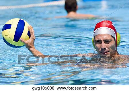 Portrait of a mid adult man playing water polo in a swimming pool Stock ...