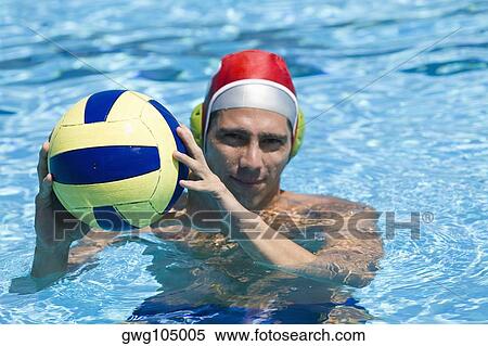 Portrait of a mid adult man playing water polo in a swimming pool View Large Photo Image Stock Photography - Portrait of a mid adult man playing water polo in a swimming pool. Fotosearch