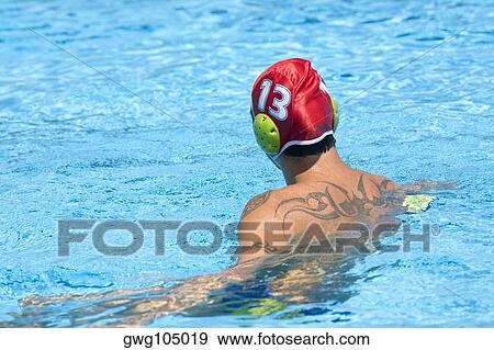 Rear view of a mid adult man in a swimming pool View Large Photo Image Stock Photo - Rear view of a mid adult man in a swimming pool. Fotosearch