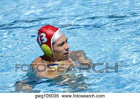 Side profile of a mid adult man playing water polo in a swimming pool View Large Photo Image Stock Photography - Side profile of a mid adult man playing water polo in a swimming pool. Fotosearch
