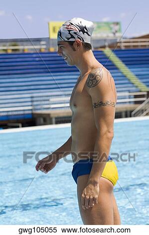 Side profile of a mid adult man standing at the poolside View Large Photo Image Stock Photography - Side profile of a mid adult man standing at the poolside. Fotosearch