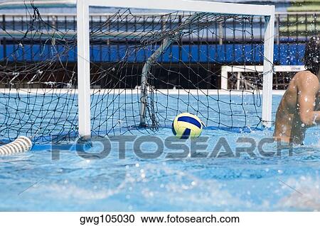Water polo player in front of a goal post in a swimming pool View Large Photo Image Stock Image - Water polo player in front of a goal post in a swimming pool. Fotosearch