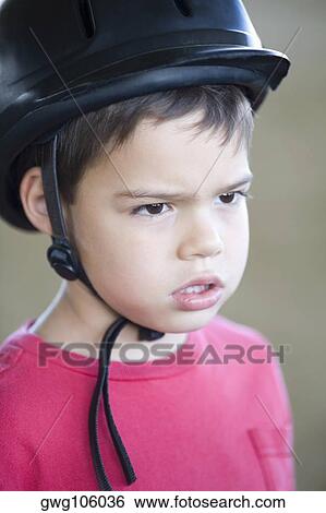 Close-up of a boy wearing a riding hat View Large Photo Image Stock Photograph - Close-up of a boy wearing a riding hat. Fotosearch
