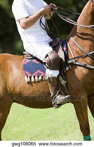 Low section view of a man riding a horse View Large Photo Image Stock Photography - Low section view of a man riding a horse. Fotosearch