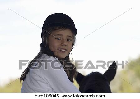 Portrait of a girl riding a horse and smiling View Large Photo Image Stock Photography - Portrait of a girl riding a horse and smiling. Fotosearch