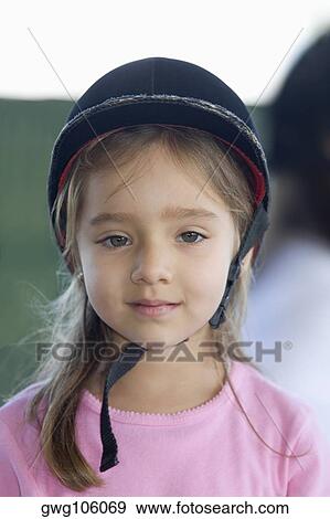Portrait of a girl wearing a riding hat View Large Photo Image Stock Photo - Portrait of a girl wearing a riding hat. Fotosearch