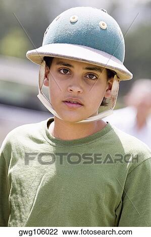 Portrait of a teenage boy wearing a polo helmet View Large Photo Image Stock Image - Portrait of a teenage boy wearing a polo helmet. Fotosearch