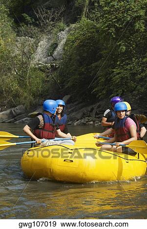 Five people rafting in a river View Large Photo Image Stock Photo - Five people rafting in a river. Fotosearch