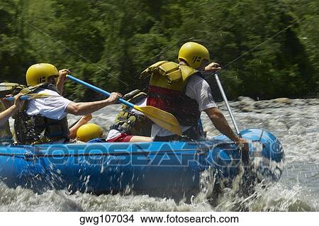 Four people rafting in a river View Large Photo Image Picture - Four people rafting in a river. Fotosearch