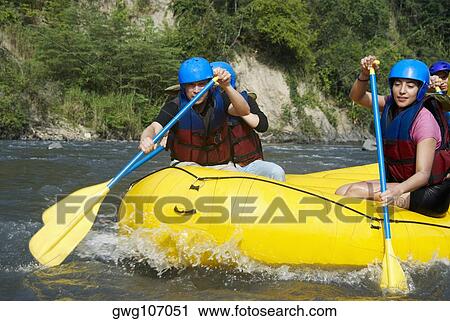 Four people rafting in a river View Large Photo Image Stock Image - Four people rafting in a river. Fotosearch