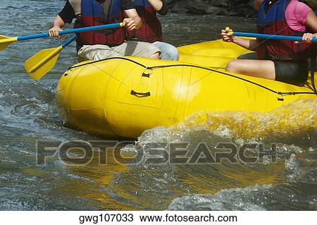 Mid section view of three people rafting in a river View Large Photo Image Stock Image - Mid section view of three people rafting in a river. Fotosearch