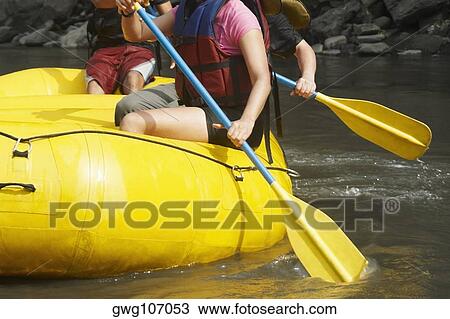 Mid section view of three people rafting in a river View Large Photo Image Stock Image - Mid section view of three people rafting in a river. Fotosearch
