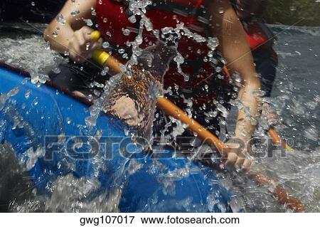 Mid section view of two people rafting in a river View Large Photo Image Stock Photo - Mid section view of two people rafting in a river. Fotosearch