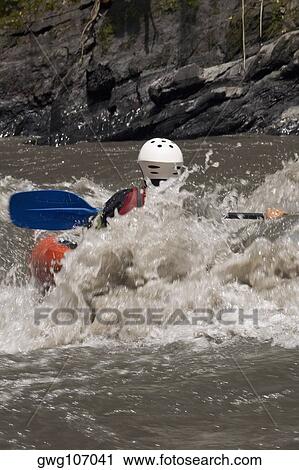 Rear view of a person kayaking in a river View Large Photo Image Stock Image - Rear view of a person kayaking in a river. Fotosearch
