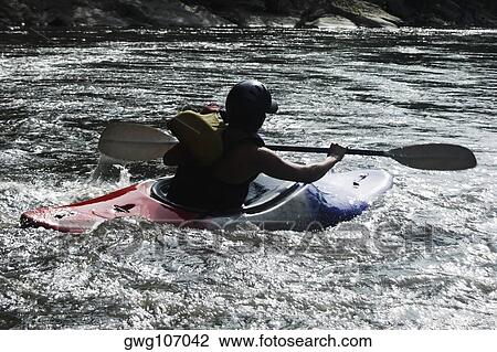 Rear view of a person kayaking in a river View Large Photo Image Stock Image - Rear view of a person kayaking in a river. Fotosearch