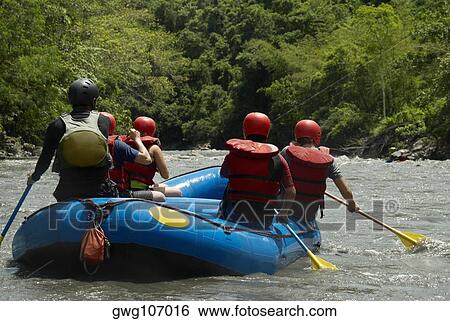 Stock Photograph - Rear view of five people rafting in a river. Fotosearch