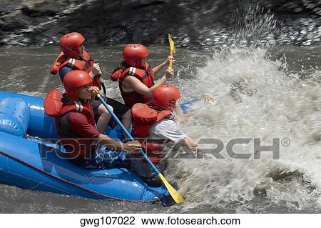 Side profile of four people rafting in a river View Large Photo Image Stock Image - Side profile of four people rafting in a river. Fotosearch