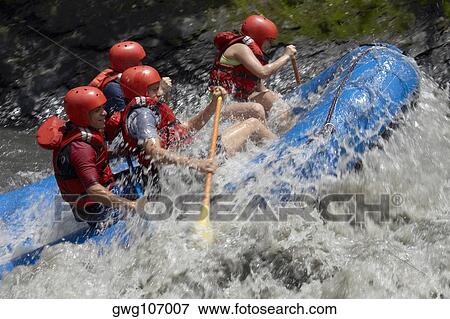 Side profile of four people rafting in a river View Large Photo Image Stock Photo - Side profile of four people rafting in a river. Fotosearch