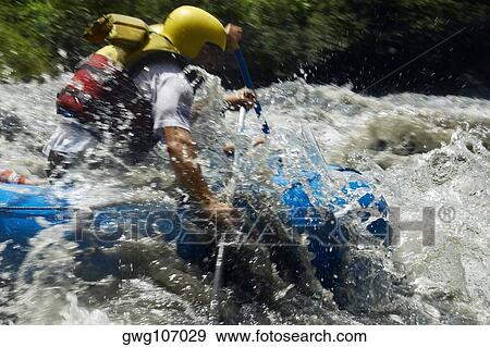 Side profile of two people rafting in a river View Large Photo Image Stock Photo - Side profile of two people rafting in a river. Fotosearch