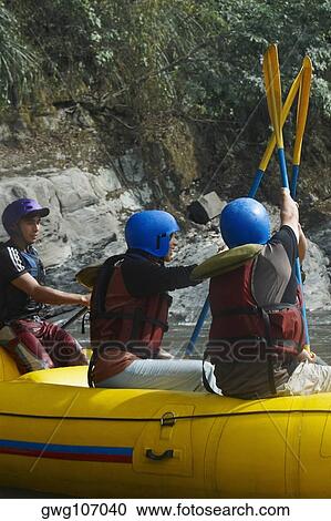 Three people on an inflatable raft View Large Photo Image Stock Image - Three people on an inflatable raft. Fotosearch