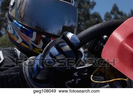 Close-up of a person go-carting View Large Photo Image Stock Photo - Close-up of a person go-carting. Fotosearch