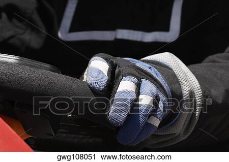 Close-up of a person's hand on the steering wheel of a racecar View Large Photo Image Stock Image - Close-up of a person's hand on the steering wheel of a racecar. Fotosearch