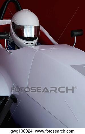 Close-up of a racecar driver in a racecar View Large Photo Image Picture - Close-up of a racecar driver in a racecar. Fotosearch