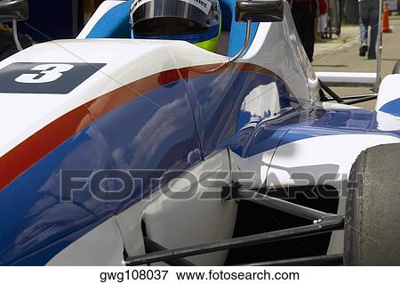 Close-up of a racecar driver in a racecar View Large Photo Image Stock Photo - Close-up of a racecar driver in a racecar. Fotosearch