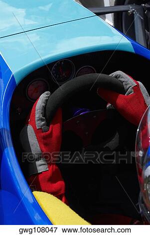 High angle view of a racecar driver's hands holding steering wheel of a racecar View Large Photo Image Stock Photo - High angle view of a racecar driver's hands holding steering wheel of a racecar. Fotosearch