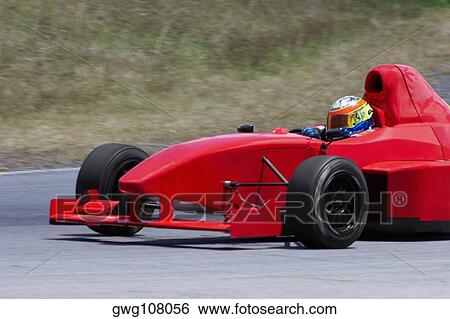 Person driving a formula one racing car on a motor racing track View Large Photo Image Stock Photograph - Person driving a formula one racing car on a motor racing track. Fotosearch