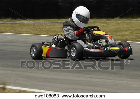 Person driving a go-cart on a motor racing track View Large Photo Image Stock Image - Person driving a go-cart on a motor racing track. Fotosearch