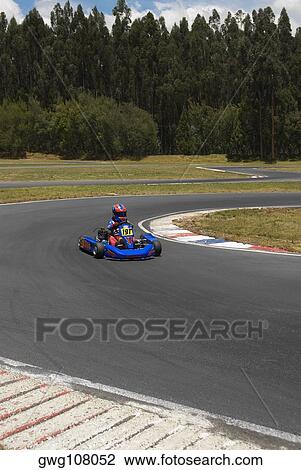 Person go-carting on a motor racing track View Large Photo Image Stock Image - Person go-carting on a motor racing track. Fotosearch